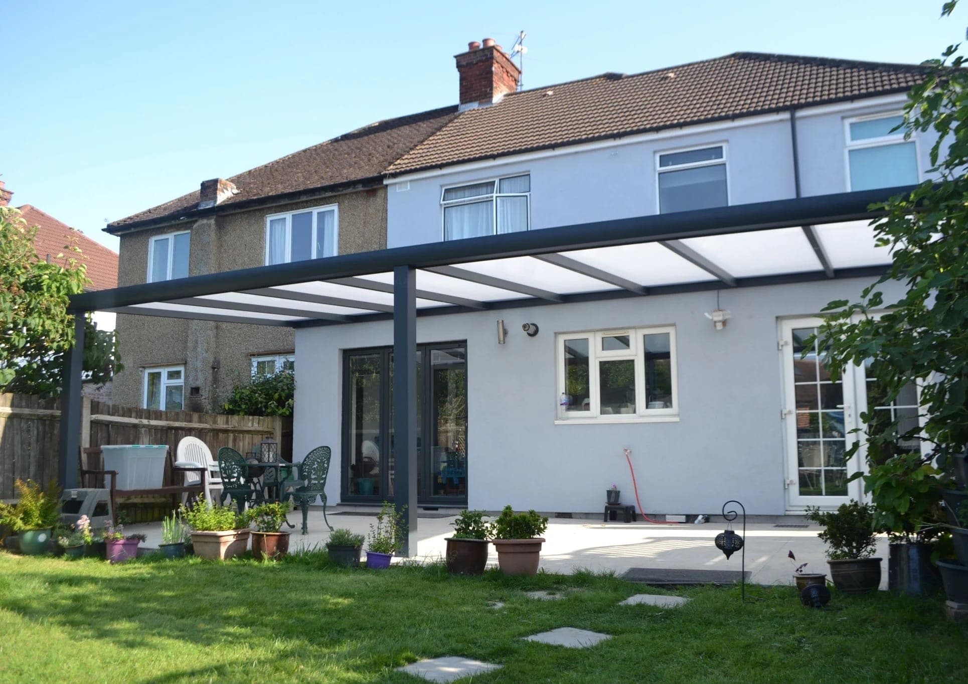 Anthracite aluminium veranda attached to a residential patio.